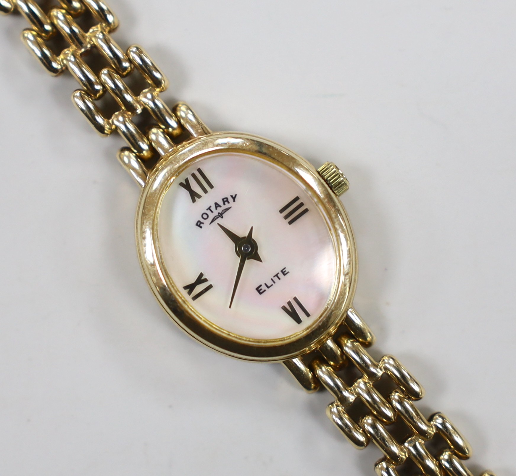 A lady's modern 9k Rotary Elite oval dial quartz wrist watch, on a 375 bracelet, overall 18cm, gross 15.4 grams.